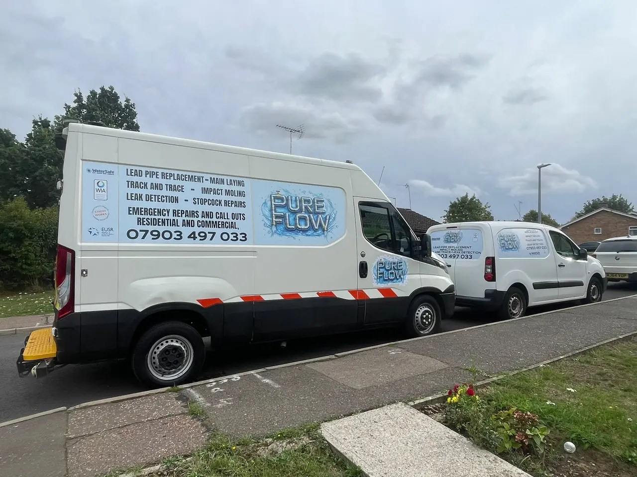PureFlow vans parked at a residential pipework project