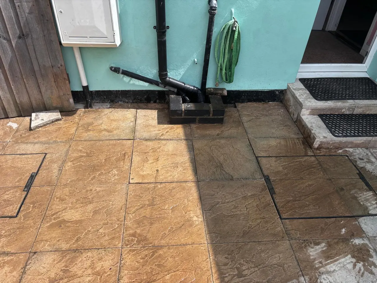 External water pipework routed neatly along a property wall