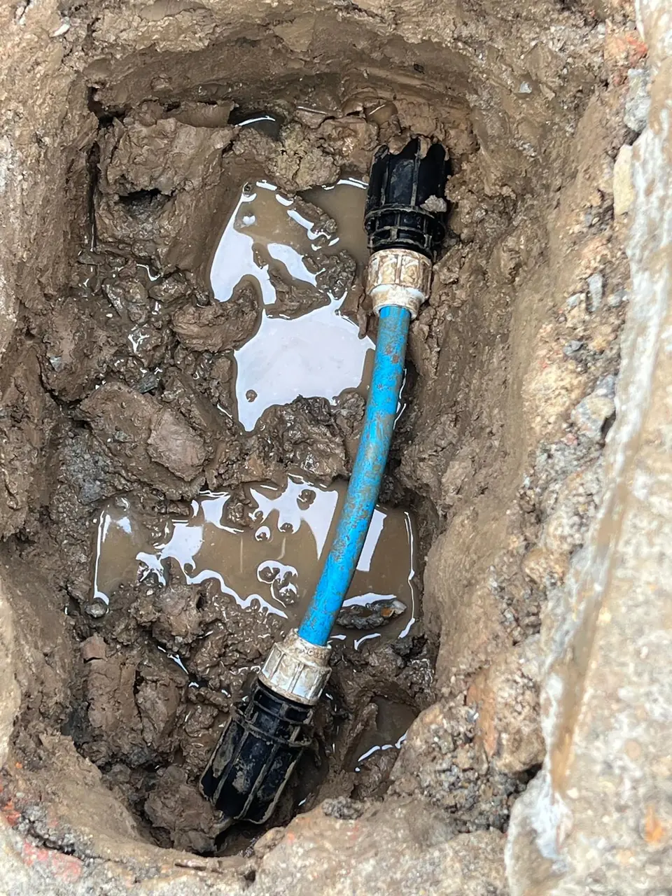 Blue MDPE water supply connected below ground