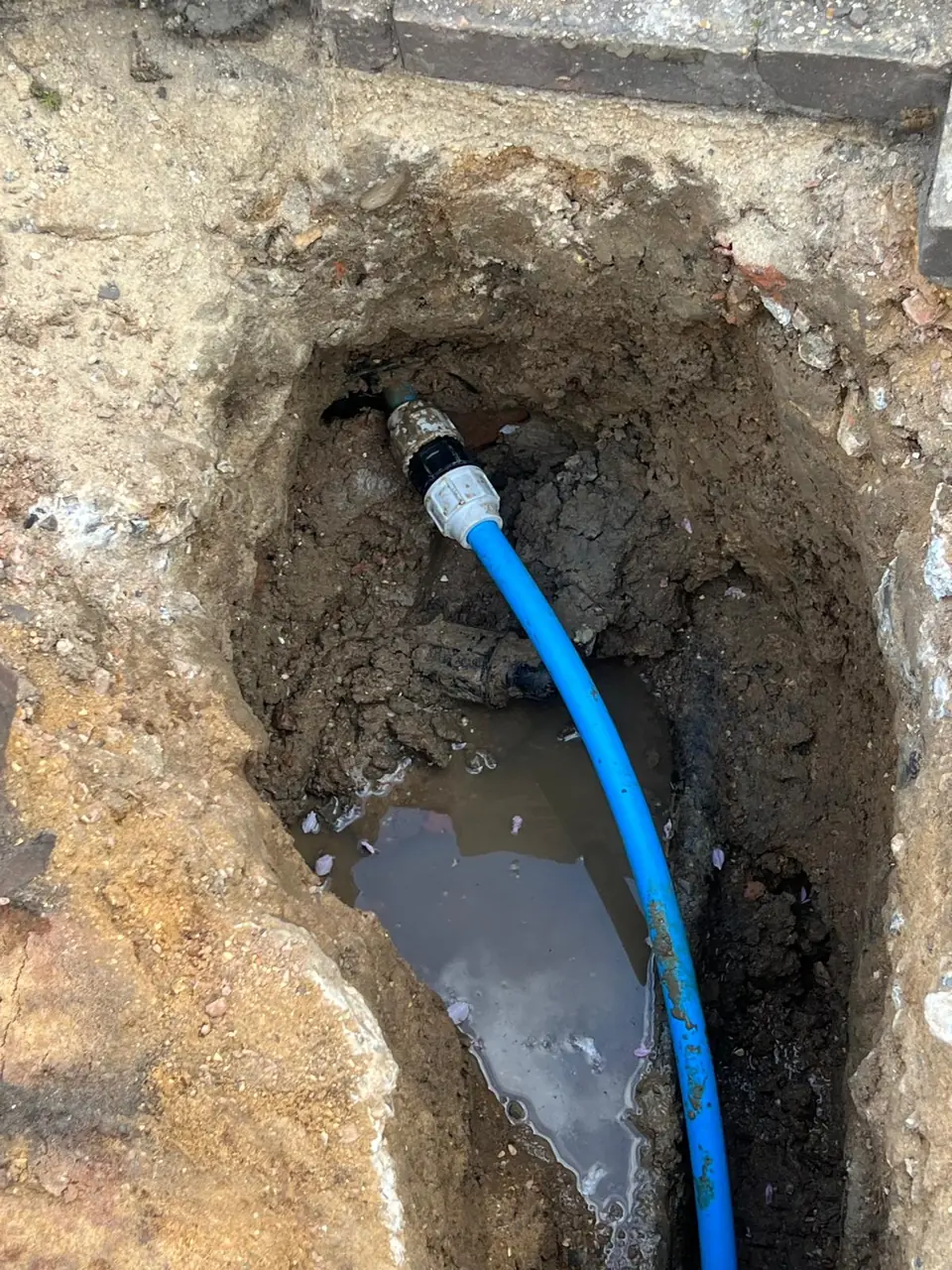 Blue MDPE pipe joined below ground