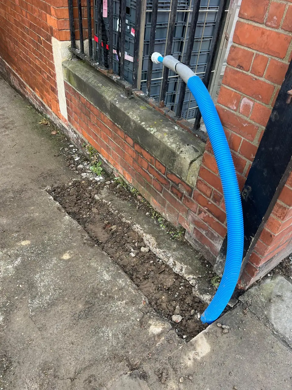Protective blue duct beside a residential property