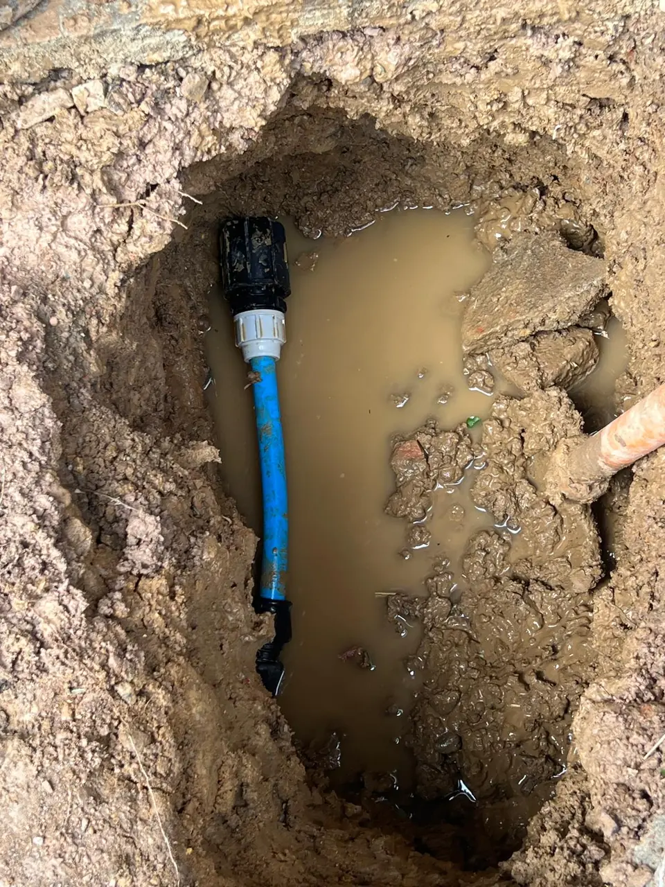Completed blue water-pipe joint below ground
