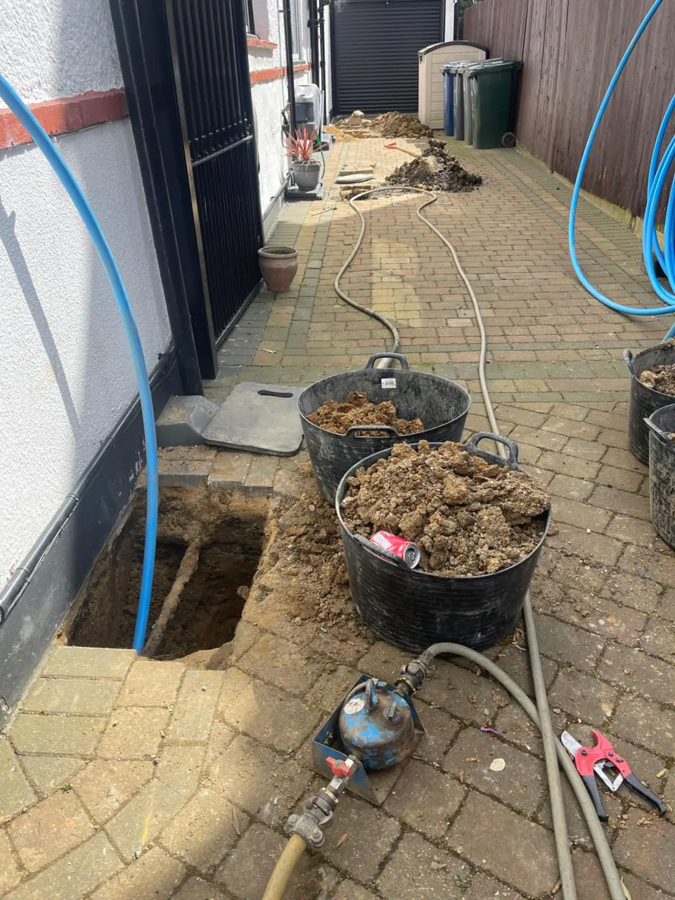 Residential block-paved driveway during underground water-supply installation