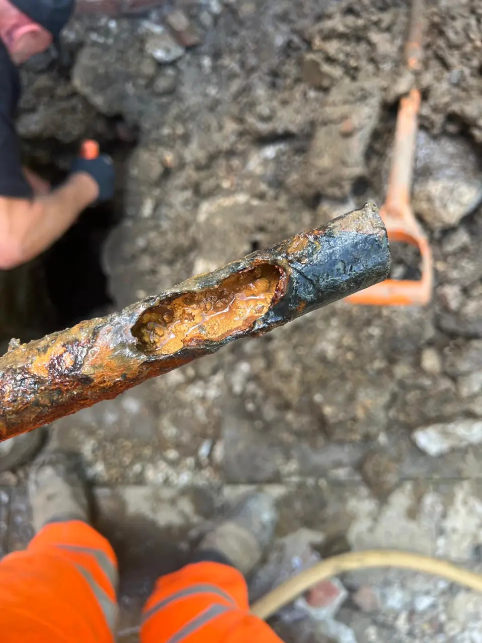 Corroded metal water pipe showing a damaged section