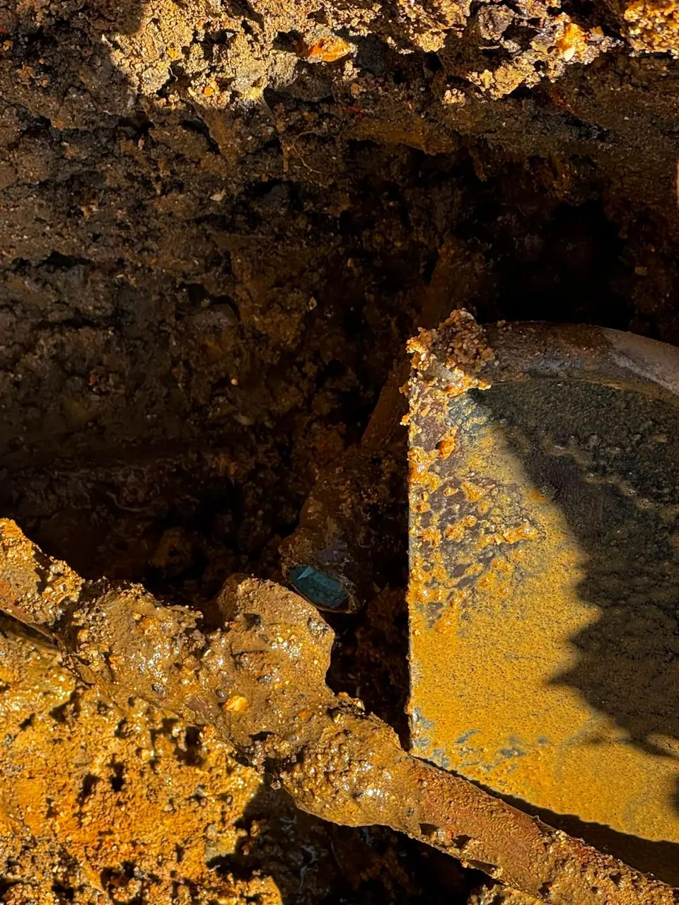 Existing underground service exposed beside an excavation