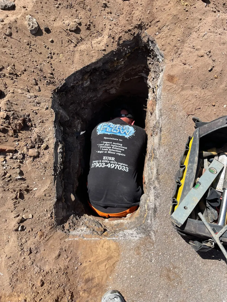 PureFlow specialist working safely within a pipe access point