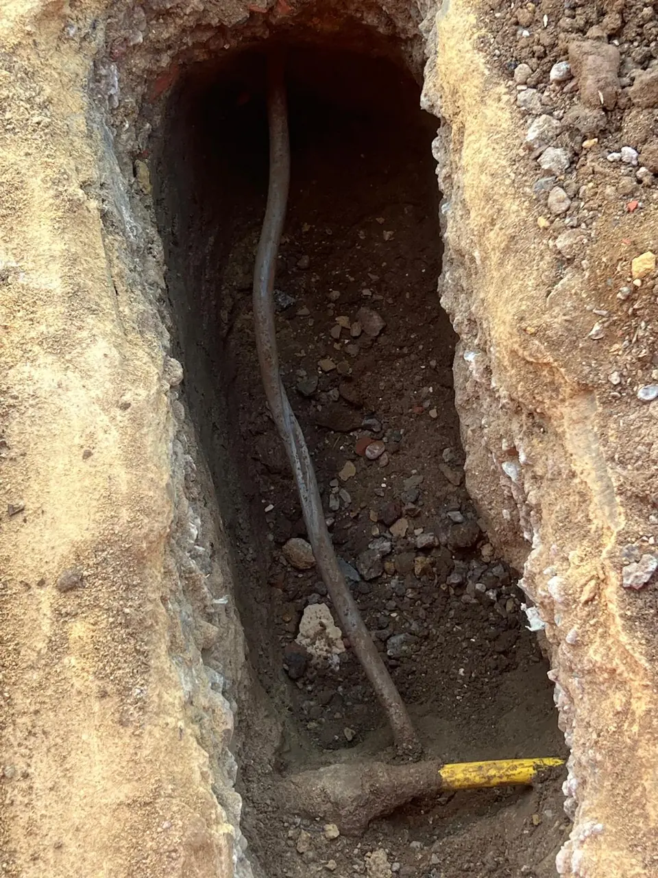 Narrow trench prepared for a replacement water supply