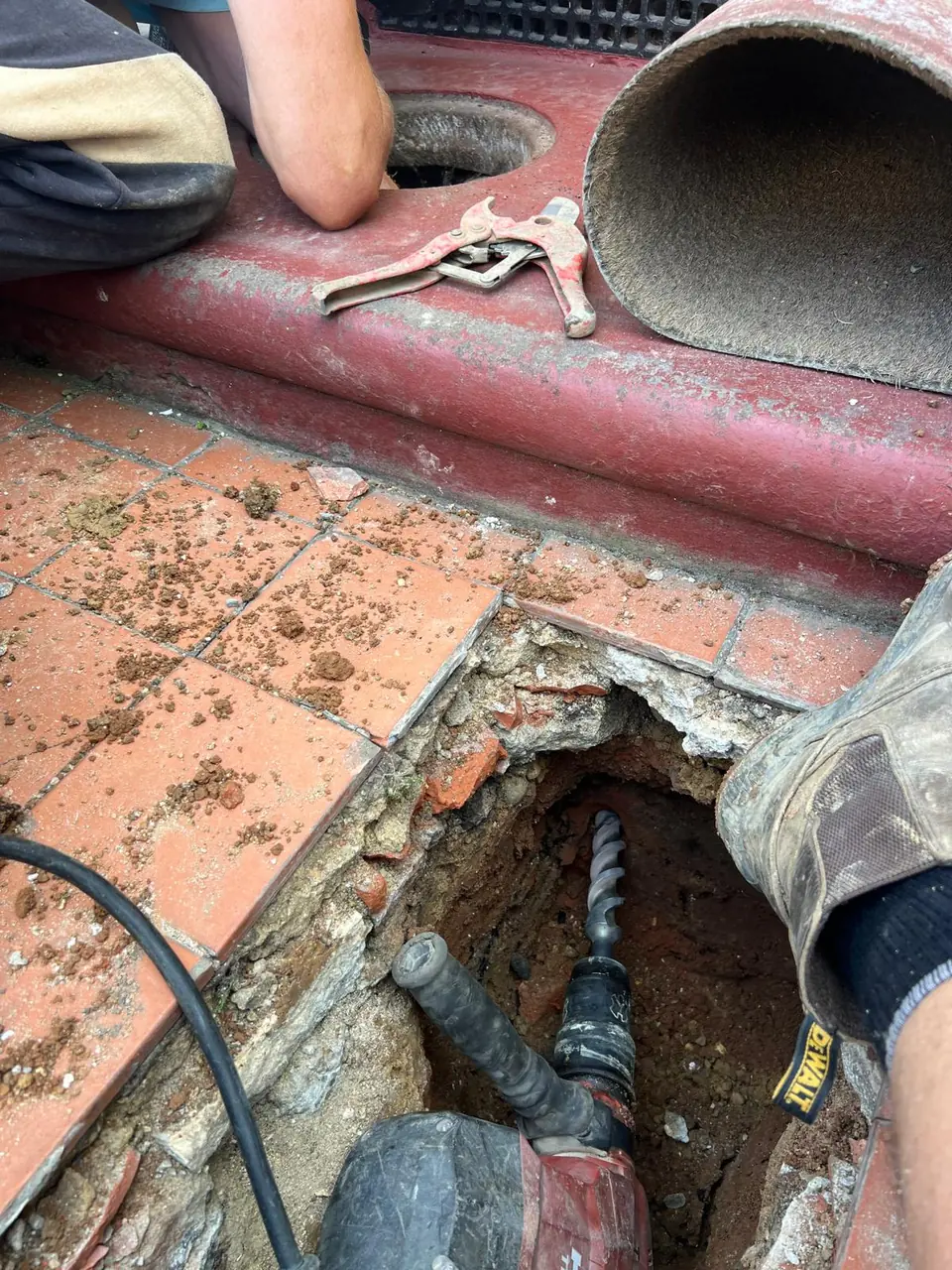 Compact pipe access point at a tiled property entrance